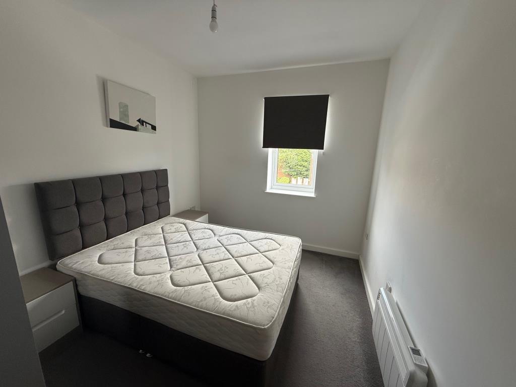 Lot: 128 - FLAT FOR INVESTMENT - Bedroom with white painted walls and grey flooring